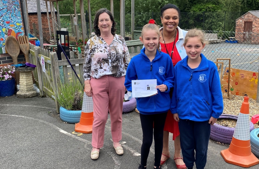 Pauline pictured with pupils and the Headteacher of St Andrew's CofE Primary School.