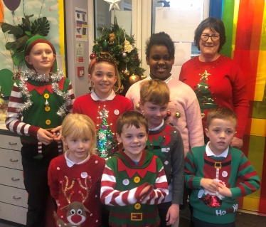 Pauline Latham OBE MP judges the Christmas jumper competition at Morley Primary School