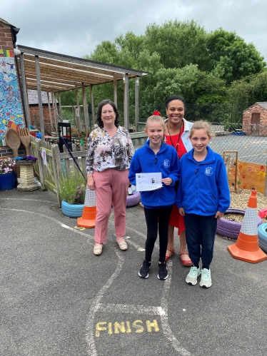 Pauline pictured with pupils and the Headteacher of St Andrew's CofE Primary School.